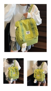 Three-view look of a green nylon backpack with soft plush bear charm and white woven label