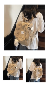Detail view of khaki canvas backpack featuring side pockets and a cute plush bear charm