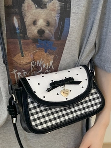 Fashionable heart-print crossbody bag with black and white grid patterns and bow detail