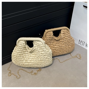 Detailed view of woven straw handbags featuring a metal frame and gold chain straps