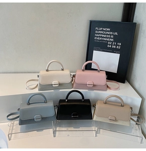 Detail view of mini crossbody bags showing five colors and mixed material textures