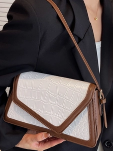 Chic two-tone shoulder bag with white croc-embossed leather and brown strap detail