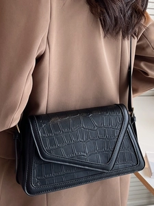 Minimalist black faux-crocodile skin shoulder bag with geometric cut flap for women