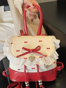 Sweet red and white lace backpack with polka dots, bow detail and heart pendant