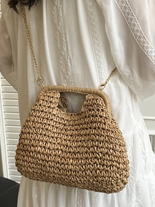 Chic woven straw handbag with wavy texture and gold chain strap for summer beach style