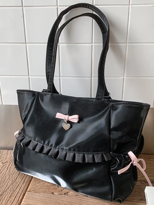 Glossy black pleated tote bag with pink bow and heart pendant in Y2K aesthetic style