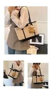 Detail of canvas tote bag with leather trim and cute brown bear pendant accessory