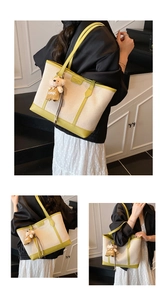 Detail of canvas tote bag with green leather trim and cute plush bear accessory