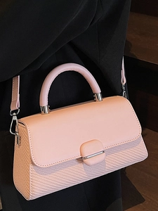 Pale pink minimalist shoulder bag with woven texture and elegant silver square lock