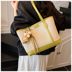 Detail showing high-quality canvas and lime green leather trim on a large tote bag