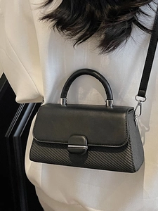 Minimalist black epi leather crossbody bag with structured flap and silver hardware details