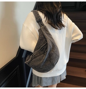 Charcoal grey washed denim sling bag shown from behind on model for casual daily use