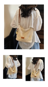 Detail of beige crochet hollow tote bag with brown leather straps and cute doll pendant