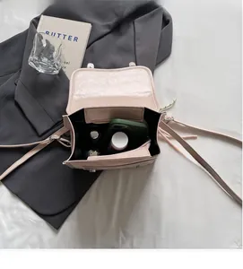 Pink PU leather crossbody bag interior showing storage for phone and cosmetics