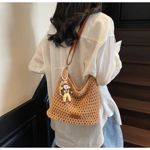Brown woven hollow-out tote bag featuring detailed diamond pattern and leather strap