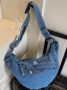 Blue denim crescent crossbody bag with multi-zipper layers and adjustable strap for women