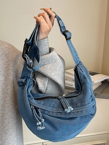 Japanese style crescent denim crossbody bag in light blue wash with large buckle strap