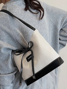 Large black and white contrast woven tote bag with leather straps for summer beach