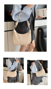 Detailed view of beige pleated shoulder bag with knotted strap and soft leather texture