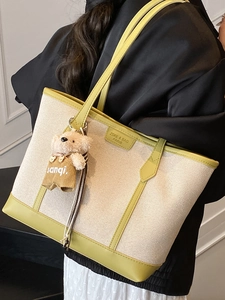 Minimalist canvas tote bag in green and cream with cute bear charm for daily commute