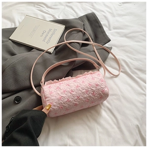 Detail of pink cylinder bag with bubble fabric, bow print and sweet ruffle trim