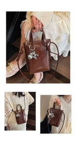 Close-up of brown faux leather mini bucket bag with silver bunny charm and sleek zipper