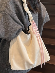 Minimalist beige tote bag with ruched shoulder strap and pink drawstring detail