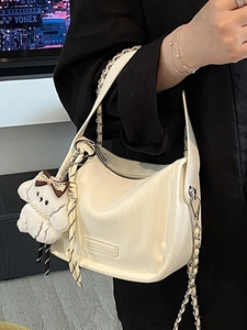 Chic cream hobo shoulder bag with silver chain strap and plush puppy charm for women