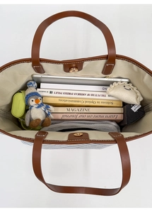 Top view showing the large capacity interior of striped tote bag with leather handles