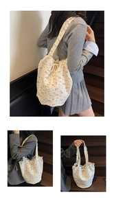 Detail of floral canvas tote bag with drawstring closure and lilac flower pattern on beige