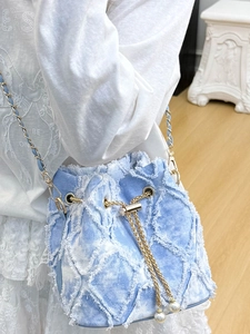 Blue denim bucket bag with frayed quilted pattern, gold chain and pearl drawstring