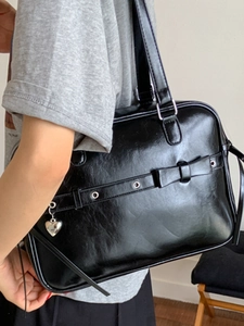 Stylish black PU leather shoulder bag with heart pendant and bow in vintage college style