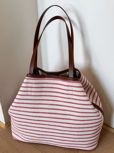 Large striped canvas tote bag with red stripes and brown leather handles for women