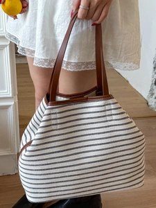 Minimalist striped canvas tote bag with brown leather handles and spacious interior