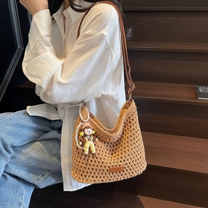Handwoven hollow tote bag with leather strap and pearl charm for summer beach vacation