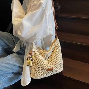 Hollow out woven tote bag in cream with brown leather straps and cute doll pendant