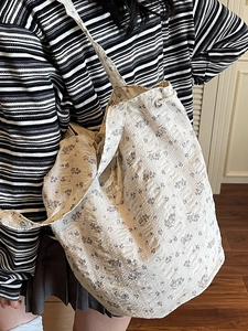 Floral canvas tote bag with seersucker texture and drawstring detail for women