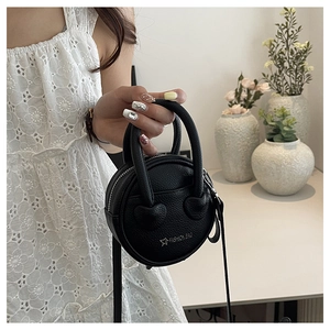 Litchi pattern PU leather round bag with twin handles and star logo shown on model