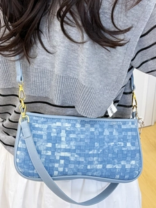Blue checkerboard woven shoulder bag with chain strap shown on model for daily styling
