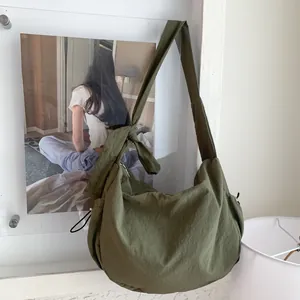 Minimalist olive green dumpling bag with adjustable wide strap for casual daily use