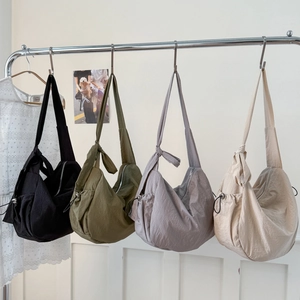 Large casual nylon dumpling crossbody bags with knotted straps in four versatile colors