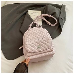 Close-up of pink quilted mini backpack featuring silver rhinestones and a metal turn-lock