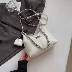 Détail du sac à main blanc en cuir ciré avec chaîne argentée et mini charme attaché
