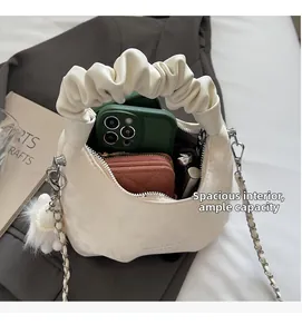 Detailed view of white cloud bag spacious interior with leather and chain shoulder strap