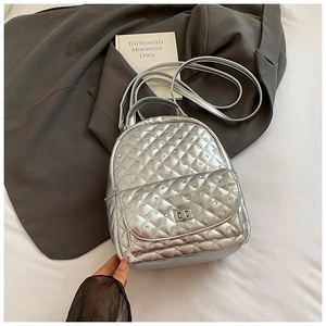 Detail view of silver mini backpack with diamond-stitched quilted pattern and metal clasp