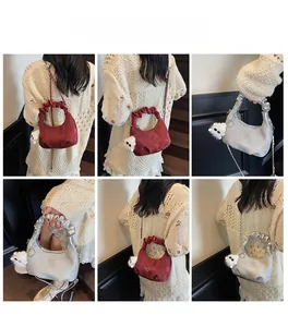 Detail showing red and silver crescent bags with ruched handles and plush charms