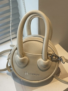 Minimalist cream round mini bag in lychee pattern leather with a chic star logo