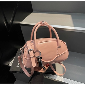 Detailed view of pink PU leather bowling bag with silver hardware and adjustable strap