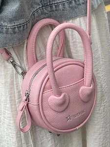 Pink round mini crossbody handbag in lychee leather grain with silver chain strap