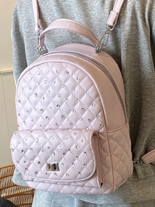 Lavender quilted leather backpack with rhinestones and metal buckle shown on model